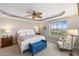 Large main bedroom with a king-size bed and access to balcony at 157 Tampa Ave # 707, Venice, FL 34285