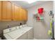 Laundry room with washer, dryer, and storage cabinets at 157 Tampa Ave # 707, Venice, FL 34285
