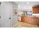Kitchen with light wood cabinets, granite counters, and tile flooring at 157 Tampa Ave # 707, Venice, FL 34285