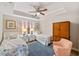 Guest bedroom with twin beds, a ceiling fan, and an armoire at 157 Tampa Ave # 707, Venice, FL 34285