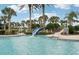 Refreshing community pool with a waterslide and palm trees at 12622 Shimmering Oak Cir, Venice, FL 34293