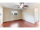 Bright bedroom with wood-look floors, window, and ceiling fan at 2831 Mayflower St, Sarasota, FL 34231