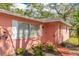 Pink house exterior with white shutters and a walkway leading to the front door at 2831 Mayflower St, Sarasota, FL 34231