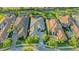 Aerial view of the home showing mature trees, lush lawns, and meticulously maintained landscaping at 7928 Matera Ct, Lakewood Ranch, FL 34202