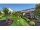 Landscaped backyard boasts a screened-in patio, lush lawn, vibrant foliage, and carefully manicured bushes at 7928 Matera Ct, Lakewood Ranch, FL 34202