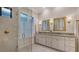 Spa-like bathroom with double vanities, granite countertops, and glass enclosed shower at 7928 Matera Ct, Lakewood Ranch, FL 34202