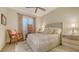 Cozy bedroom with neutral tones, floral curtains, and plush bedding at 7928 Matera Ct, Lakewood Ranch, FL 34202