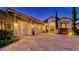 Exterior showcases a three-car garage, lush plantings, and paver driveway leading up to the entrance at 7928 Matera Ct, Lakewood Ranch, FL 34202