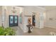 Grand foyer with ornate double doors, chandelier, and decorative accents, leading to other rooms at 7928 Matera Ct, Lakewood Ranch, FL 34202