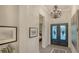 Interior entryway showcasing decorative lighting, iron double doors, and a view into the main living space at 7928 Matera Ct, Lakewood Ranch, FL 34202