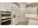 Contemporary kitchen with stainless steel appliances, white cabinetry, and stylish tile backsplash at 7928 Matera Ct, Lakewood Ranch, FL 34202
