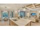 Gourmet kitchen island with counter seating and a seamless transition to the luxurious living area at 7928 Matera Ct, Lakewood Ranch, FL 34202