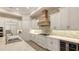 Spacious kitchen with stainless steel appliances, a wine cooler, and custom cabinetry at 7928 Matera Ct, Lakewood Ranch, FL 34202