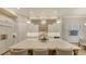Spacious kitchen island with seating, pendant lighting, and views of the open-concept dining area at 7928 Matera Ct, Lakewood Ranch, FL 34202