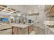 Open concept kitchen with large island, stainless appliances, and seamless flow to the living area at 7928 Matera Ct, Lakewood Ranch, FL 34202