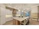 Open kitchen features an island with seating, modern appliances, and a view of the breakfast nook at 7928 Matera Ct, Lakewood Ranch, FL 34202