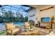 Elegant screened-in lanai featuring comfortable seating, a pool view, and stylish coastal decor at 7928 Matera Ct, Lakewood Ranch, FL 34202