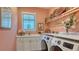Charming laundry room with front load washer and dryer, sink, and plenty of storage space at 7928 Matera Ct, Lakewood Ranch, FL 34202