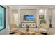Comfortable living room featuring a large TV, cozy seating, and decorative wood accents at 7928 Matera Ct, Lakewood Ranch, FL 34202