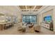 Open living space features stylish furnishings, coffered ceiling, and access to the outdoor lanai at 7928 Matera Ct, Lakewood Ranch, FL 34202