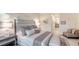 Tastefully designed main bedroom featuring neutral colors, a lounge chair, and ensuite bath access at 7928 Matera Ct, Lakewood Ranch, FL 34202