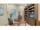 Beautiful home office space with wood desk, built-in shelves, and convenient ladder access at 7928 Matera Ct, Lakewood Ranch, FL 34202