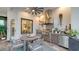 Outdoor kitchen with stainless steel appliances, dining area, and stylish decor under a ceiling fan at 7928 Matera Ct, Lakewood Ranch, FL 34202