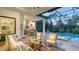Screened-in outdoor living space with pool, spa, seating and dining areas, plus an outdoor kitchen at 7928 Matera Ct, Lakewood Ranch, FL 34202