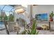 Relaxing screened patio with comfortable seating and lush plant life, perfect for entertaining at 7928 Matera Ct, Lakewood Ranch, FL 34202