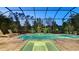 Relaxing screened pool with integrated jacuzzi and lounge chairs, surrounded by lush landscaping at 7928 Matera Ct, Lakewood Ranch, FL 34202