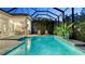 Beautiful screened pool with lounge chairs, manicured landscaping, and a covered patio provides a perfect outdoor retreat at 7928 Matera Ct, Lakewood Ranch, FL 34202