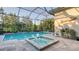 Stunning screened pool and spa surrounded by lush landscaping, providing ultimate relaxation at 7928 Matera Ct, Lakewood Ranch, FL 34202