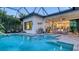 Inviting pool area with a jacuzzi, steps leading into the water, and access to indoor and outdoor living spaces at 7928 Matera Ct, Lakewood Ranch, FL 34202