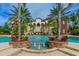 Beautiful community pool with fountains and a building in the background with stairs at 7928 Matera Ct, Lakewood Ranch, FL 34202