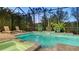 Inviting screened pool with lounge chairs and lush landscaping offers a private oasis for relaxation and enjoyment at 7928 Matera Ct, Lakewood Ranch, FL 34202