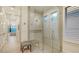 Luxurious glass shower enclosure featuring stone tile work and natural light from nearby windows at 7928 Matera Ct, Lakewood Ranch, FL 34202