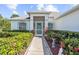 Inviting entryway with a light teal door and well-manicured landscaping at 7922 49Th E Ave, Bradenton, FL 34203