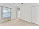 Well-lit bedroom with a window and double doors at 1269 Backspin Dr, Englewood, FL 34223