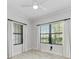 Bedroom with two windows, ceiling fan and tile floors at 1269 Backspin Dr, Englewood, FL 34223