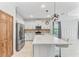 Modern kitchen with white cabinets, a large island, and stainless steel appliances at 1269 Backspin Dr, Englewood, FL 34223
