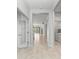 Bright entry hall with tile flooring and views into the living areas at 1269 Backspin Dr, Englewood, FL 34223