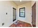 Front entry with glass door and tile flooring at 1269 Backspin Dr, Englewood, FL 34223