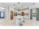 Modern kitchen featuring white cabinets, marble countertops, and stainless steel appliances at 1269 Backspin Dr, Englewood, FL 34223