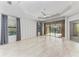 Spacious main bedroom with tile floors, ceiling fan, and access to a patio at 1269 Backspin Dr, Englewood, FL 34223