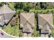 Three homes with tile roofs viewed from above, showcasing a community's architectural style at 1269 Backspin Dr, Englewood, FL 34223