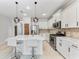 Modern kitchen with white cabinets, stainless steel appliances, and a large island at 1269 Backspin Dr, Englewood, FL 34223