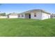 Large backyard with grassy area and home view at 2775 Pecan St, North Port, FL 34287