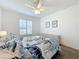 Bedroom with a queen bed, dresser, and ceiling fan at 54 Medalist Pl, Rotonda West, FL 33947