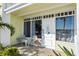 Inviting condo exterior featuring a private patio with seating for two at 611 Destiny Dr # 107, Ruskin, FL 33570