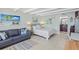 Open studio with sofa, bed, and access to balcony and water views at 611 Destiny Dr # 107, Ruskin, FL 33570